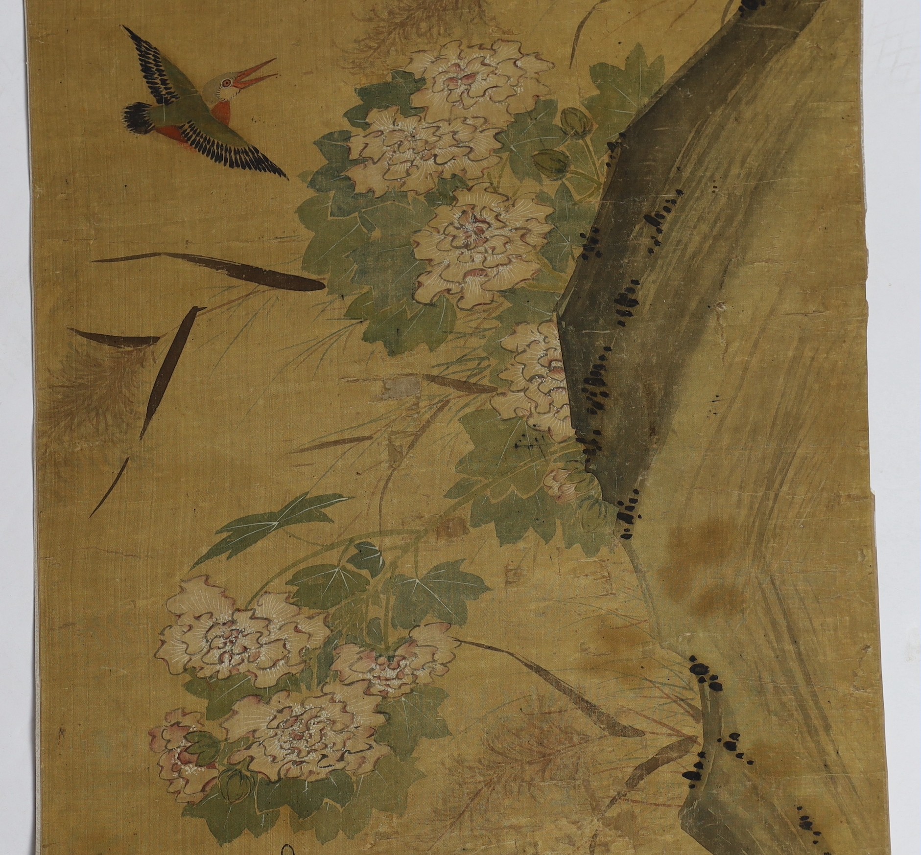 A Chinese scroll painting on silk of birds, rockwork and plants overhanging a pond, 19th century, image 164.5cm x 50.5cm